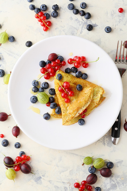 Summer crepe with berries on white plate - Фото, изображение