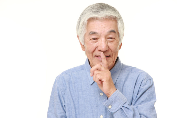 senior Japanese man whith silence gestures  - Фото, изображение