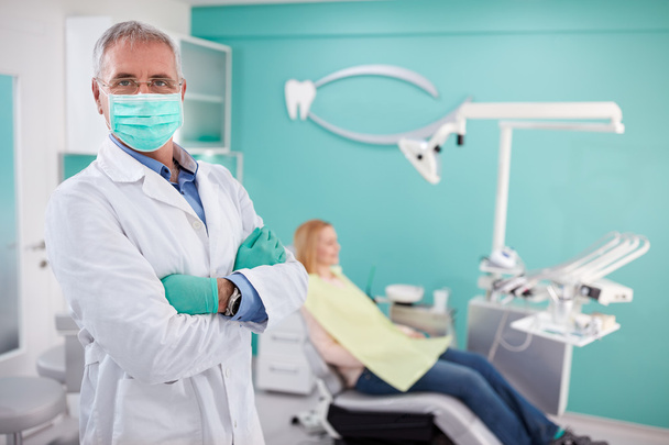 Dentist with protecting equipment posing in dental clinic   - Zdjęcie, obraz