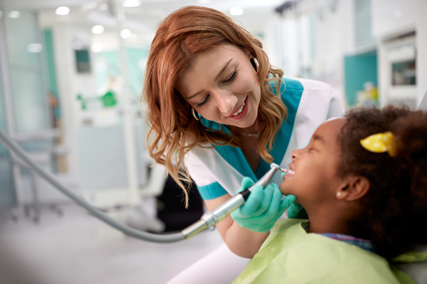 Black kid with female dentist in dental clinic  - Photo, image