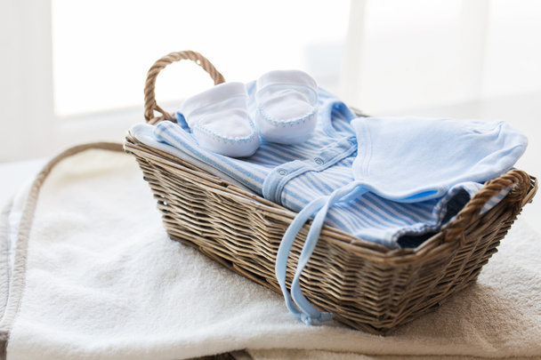 close up of baby clothes for newborn boy in basket - Fotoğraf, Görsel