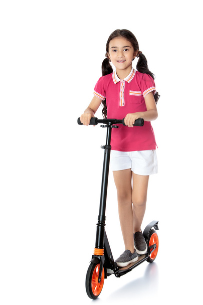 girl riding a scooter - Фото, изображение