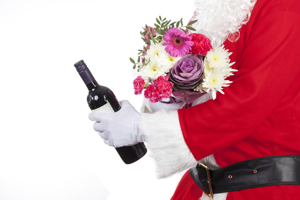 Father christmas offering a bunch of fresh flowers - Photo, Image