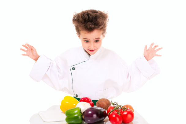 Little boy chef in uniform cooking vegatables - Valokuva, kuva