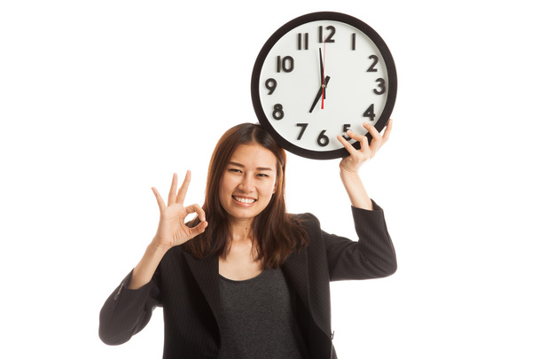 Young Asian business woman show OK with a clock. - Φωτογραφία, εικόνα