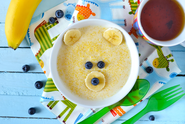 Kids breakfast, porridge with fruits and berries, face bears - Fotó, kép