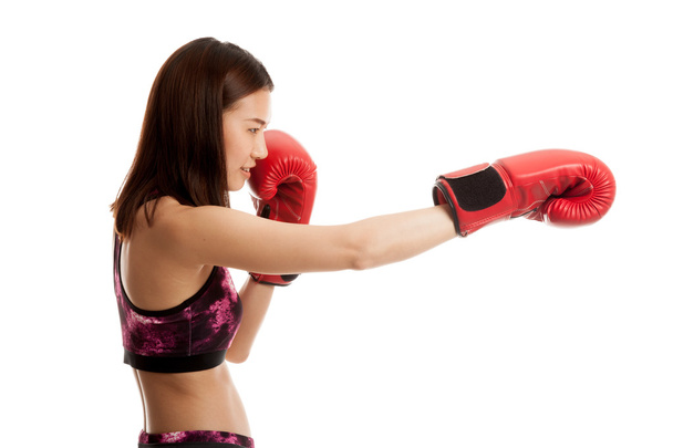 Beautiful healthy Asian girl with red boxing glove. - Zdjęcie, obraz
