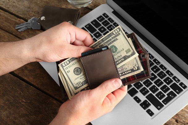 Man hands with laptop and wallet  - Photo, Image