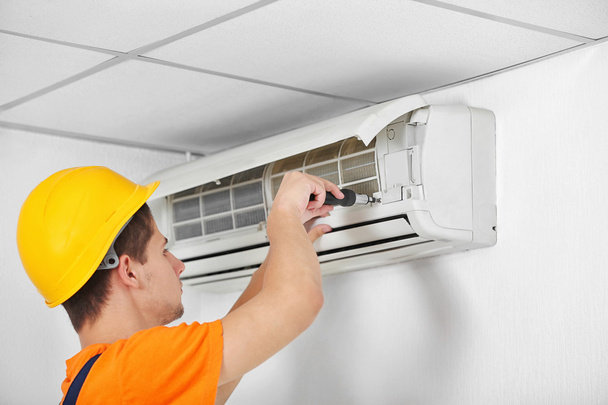 Technician repairing air conditioner  - Фото, зображення