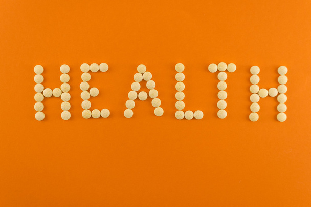 Health word written with pills of supplement - Foto, Bild