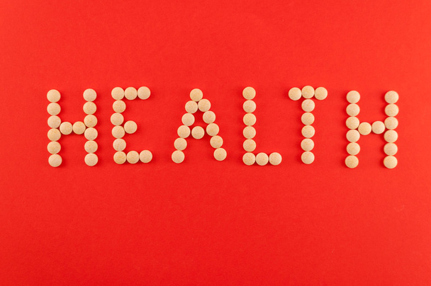 Health word written with pills of supplement - Фото, зображення