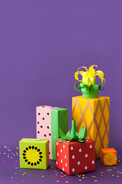 Gifts wrapped in colored paper. Gifts like fruit. Fruit boxes. - Photo, image