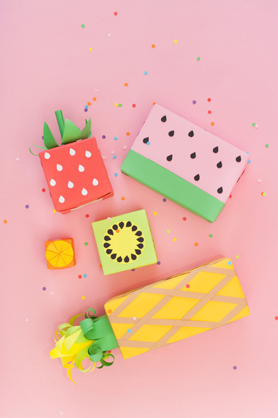 Gifts wrapped in colored paper. Gifts like fruit. Fruit boxes. - Фото, изображение