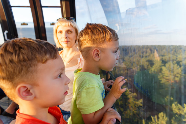 Brothers-twins and ride with mom on the cable car - Фото, зображення