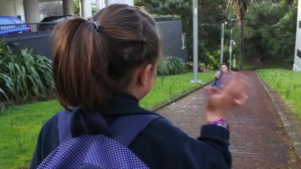 Little girl going to school wave goodbye to her mother - Footage, Video