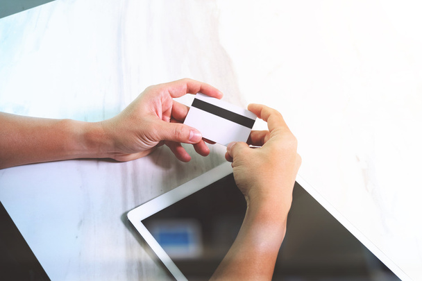 Businessman hands holding plastic credit card and using digital  - Foto, imagen
