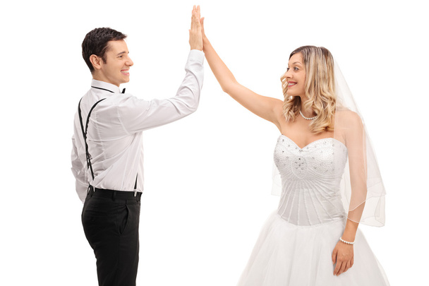 Groom and bride high-fiving each other - Foto, Bild