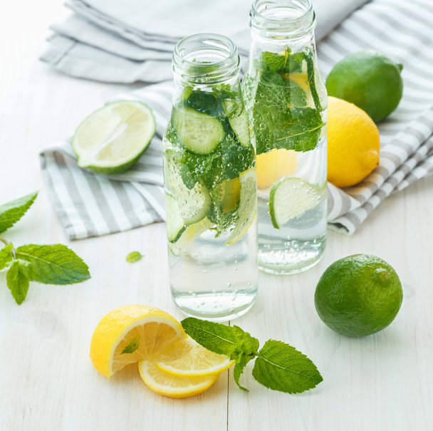 Infused water with citrus and mint in glass bottles - Φωτογραφία, εικόνα