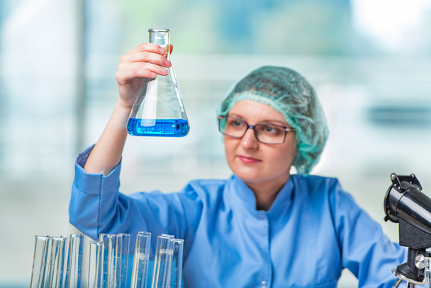 Experienced lab assistant working on chemical solutions - Photo, Image