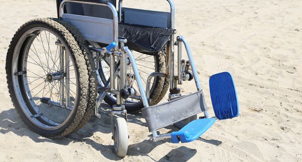 Wheelchair on the beach in summer - Photo, Image