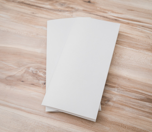 Trifold white template paper on wood texture . - Foto, immagini