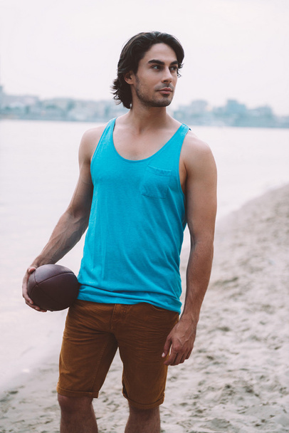 Man holding American football ball  - Photo, Image