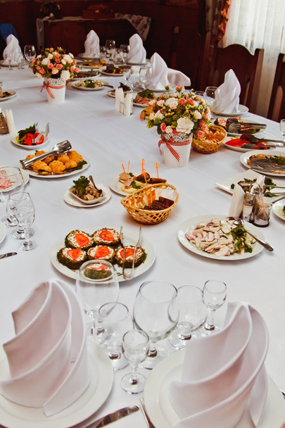 Elegant beautiful decorated table with meals and tableware at wedding reception closeup - Photo, Image