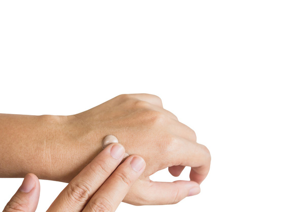 Isolated hands applying sunscreen or lotion on white background - Photo, Image