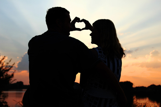 happy couple silhouettes on sunset  - Photo, Image