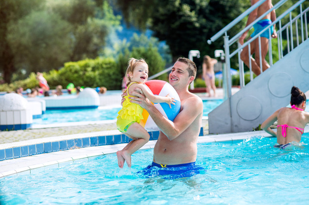 Father with his daughter in swimming pool. Sunny summer. - Fotoğraf, Görsel