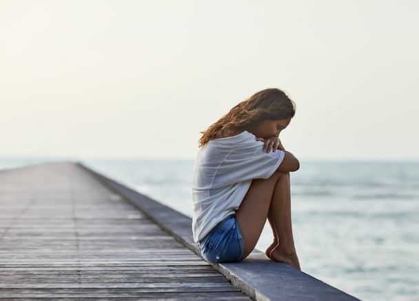 Sad lonely beautiful woman on pier - Photo, Image
