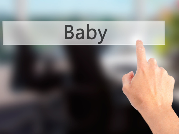 Baby - Hand pressing a button on blurred background concept on v - Photo, Image