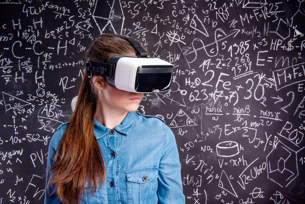 Beautiful woman wearing virtual reality goggles against big blac - Φωτογραφία, εικόνα