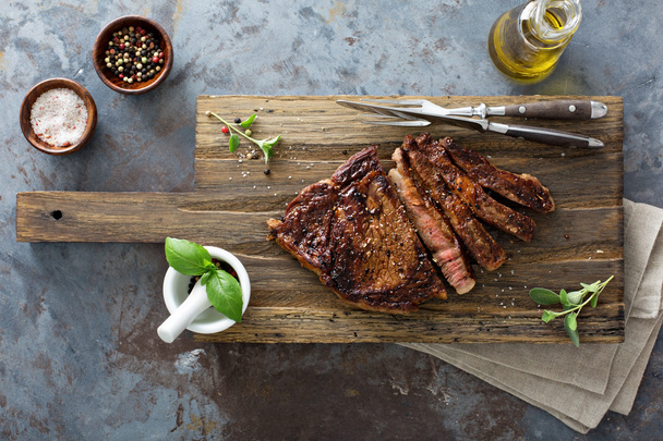 Ribeye steak on a cutting board top view - Foto, Imagen