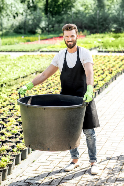 Handsome gardener with huge bucket - Valokuva, kuva