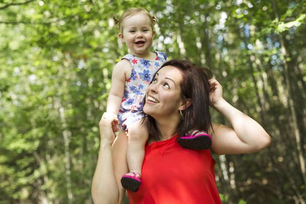 Mother and daughter in forest having fun - Foto, imagen