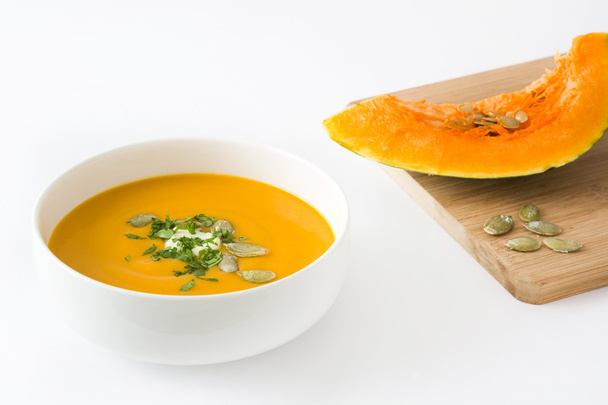 Pumpkin soup with cream and pumpkin seeds isolated on white background - Photo, Image