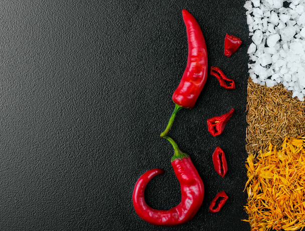 Two pepper chili and cutted chili.Stripe of sea salt, cumin and  - Φωτογραφία, εικόνα