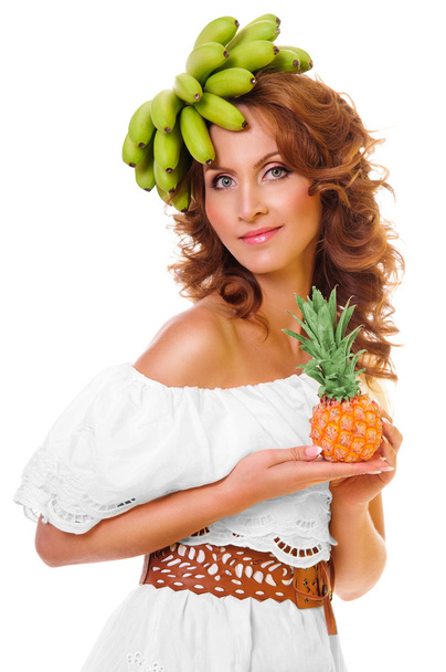 Pretty girl with bananas and pineapple over head - Фото, изображение