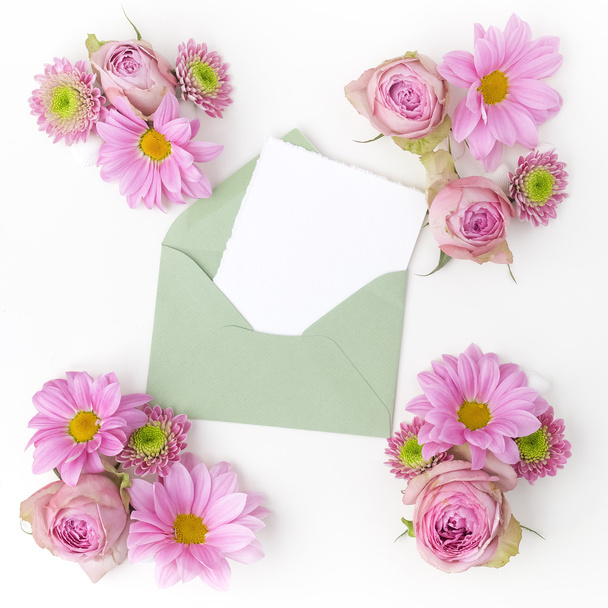 Envelop with pink flowers frame. Flat lay. Top view - Photo, Image