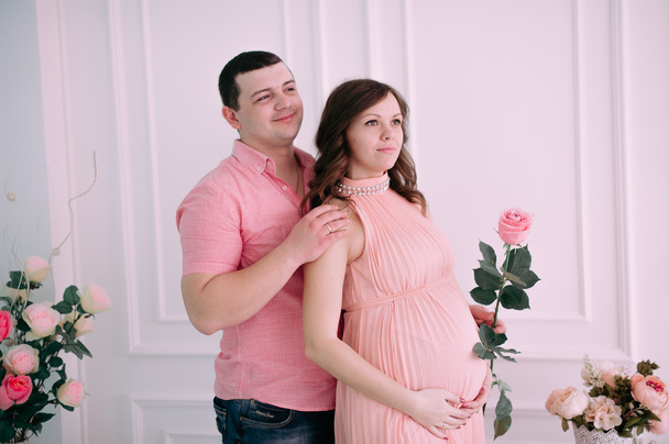 Rodina čeká na narození dítěte. Těhotná žena a její manžel na sobě bílé oblečení - Fotografie, Obrázek