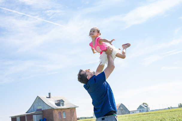 Father with young daughter having fun outside - Photo, image