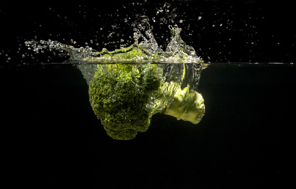 Photo of a vegetables dropped under water - Photo, image