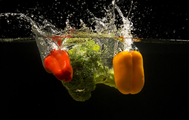 Photo of a vegetables dropped under water - Фото, зображення