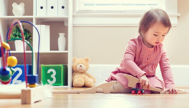 Happy toddler girl playing with toys - Zdjęcie, obraz