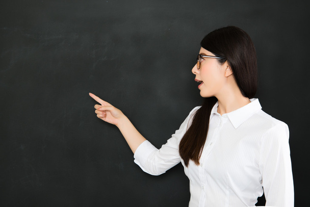 young asian teacher pointing a question on blackboard - Foto, afbeelding