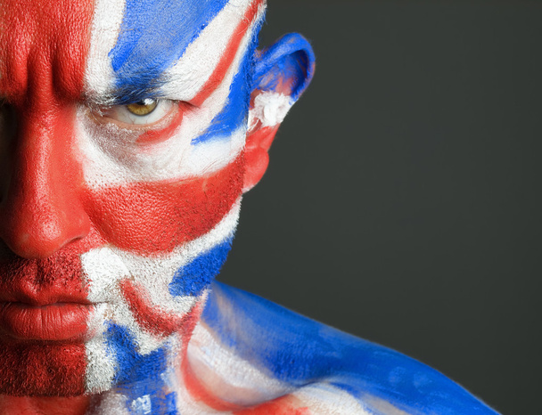 Man with his face painted with the flag of United Kingdom - Фото, изображение