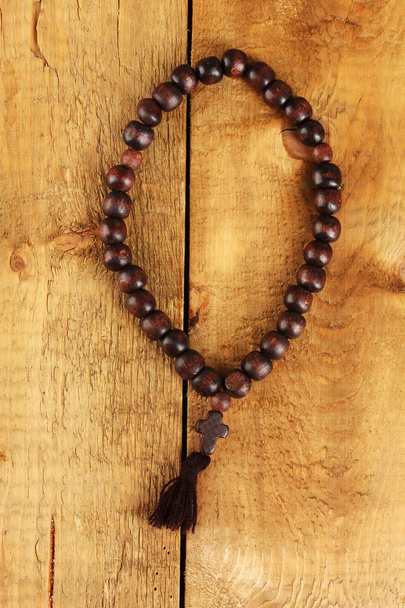 The Wooden rosary beads on wooden background close-up - Foto, immagini