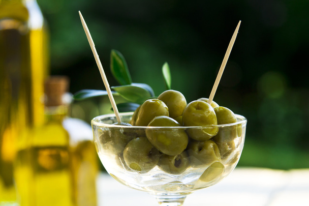 glass cup green olives stuffed with background field - Photo, image