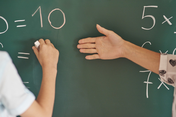 Teacher and her pupil next to the blackboard  - Foto, Imagen